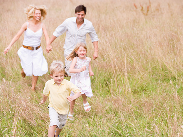 family running around in the field at Green Haven Estates Okotoks Alberta